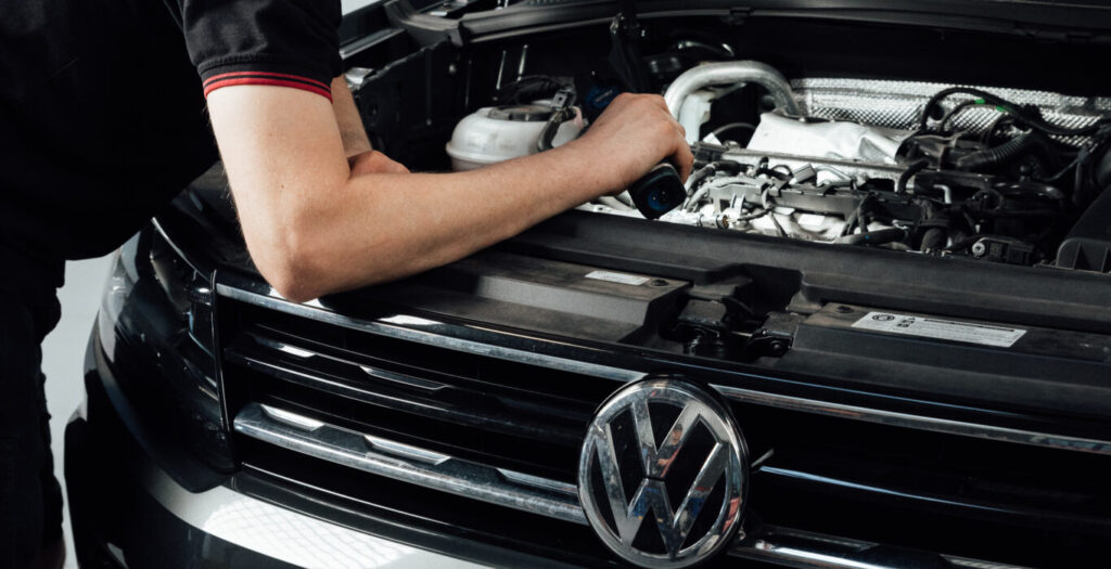 Certified Volkswagen technician at LeMans Motors Woolloongabba examining german vehicle