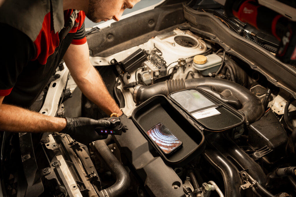 Certified Mercedes-Benz technician at LeMans Motors Woolloongabba examining luxury vehicle
